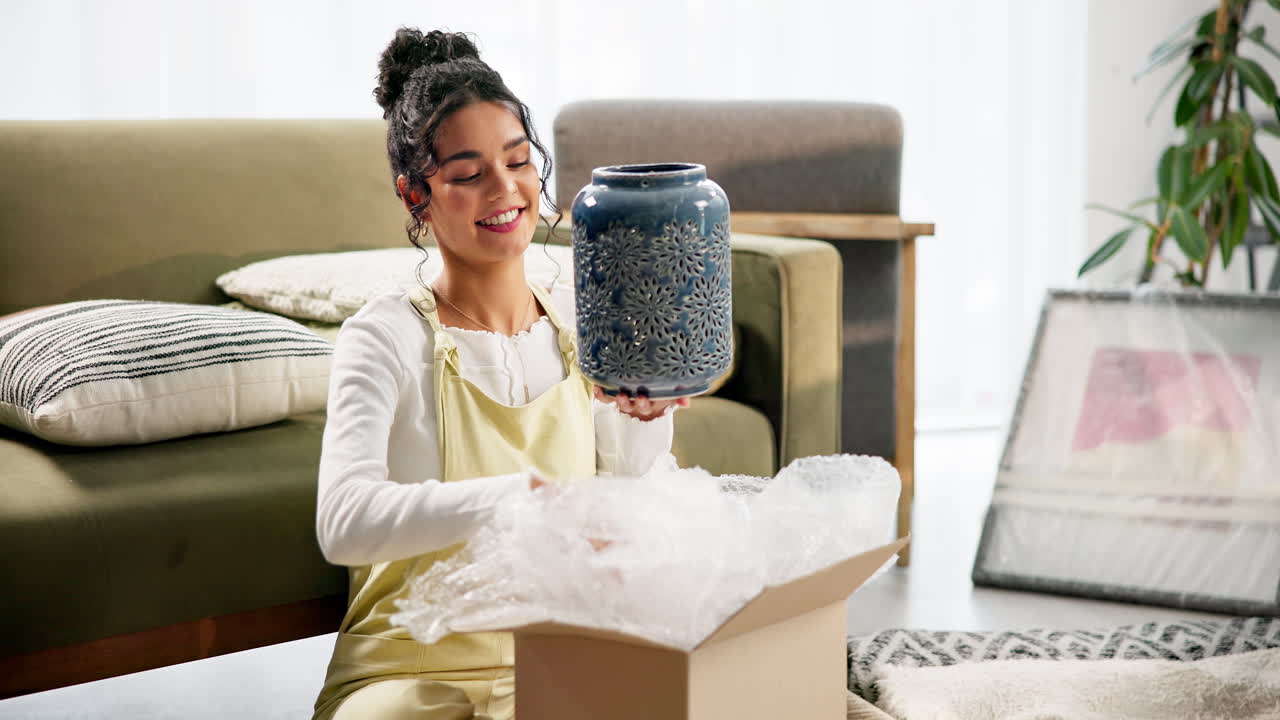 Woman unpacking a vase from a box at home