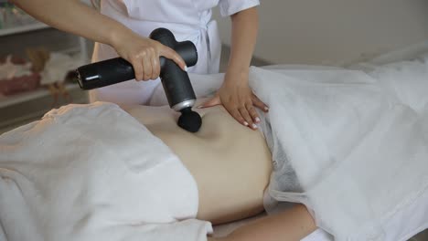 woman receiving abdominal massage therapy