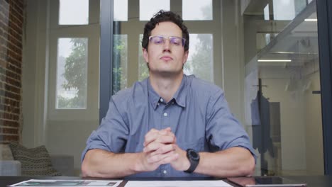 Portrait-of-man-checking-a-document-at-office