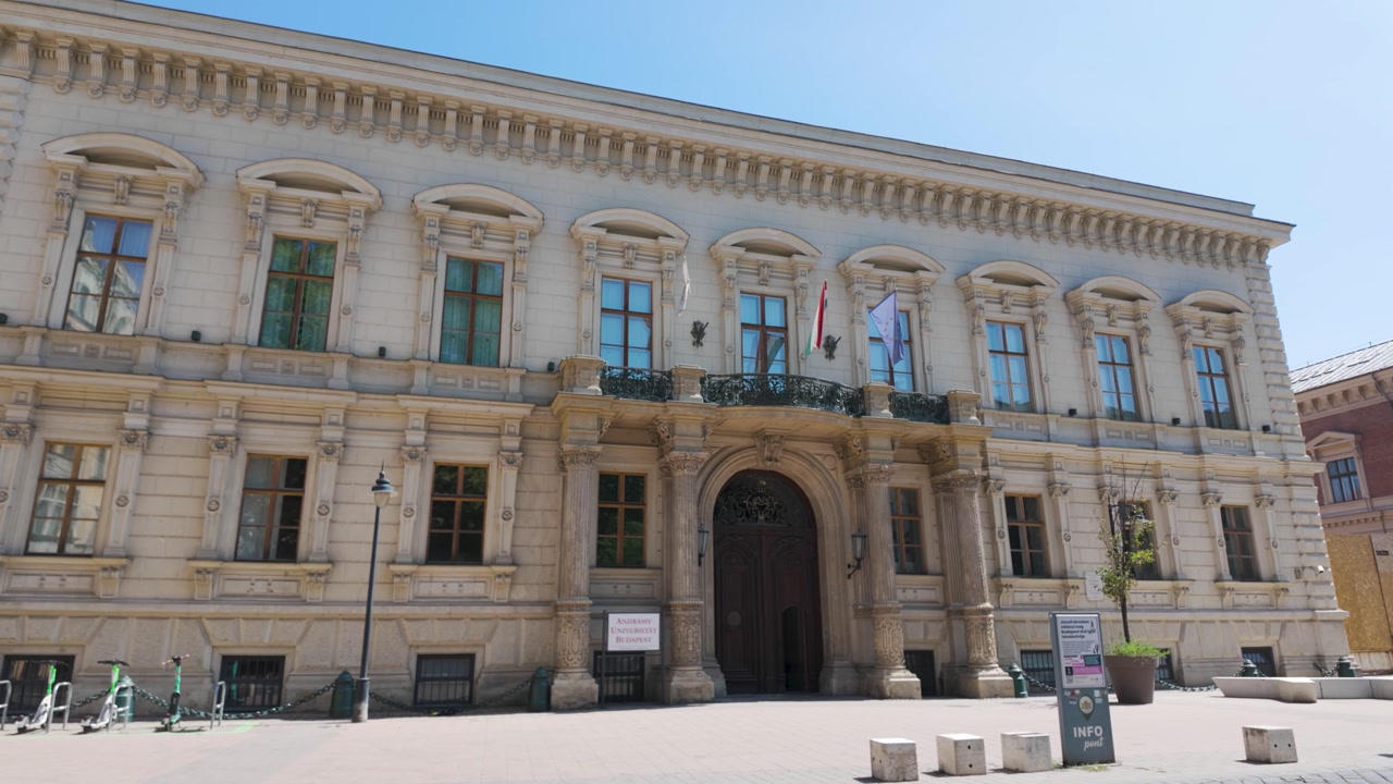 Neoclassical exterior of Andrássy University in Budapest, emphasizing its monumental architecture, decorative elements, and academic heritage