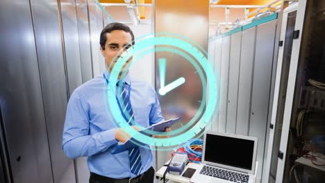 Animation-of-moving-clock-over-biracial-man-in-server-room