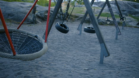 empty playground swings swinging