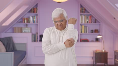 sick indian old man suffering from arthritis