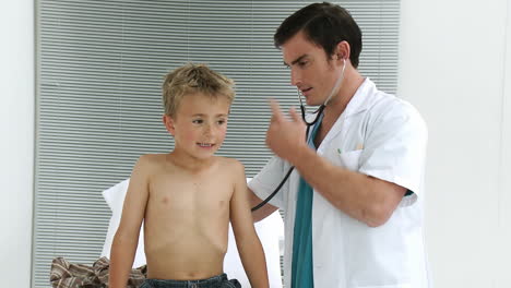 doctor examinating a child with stethoscope