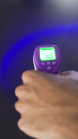 taking body temperature with a non-contact thermometer