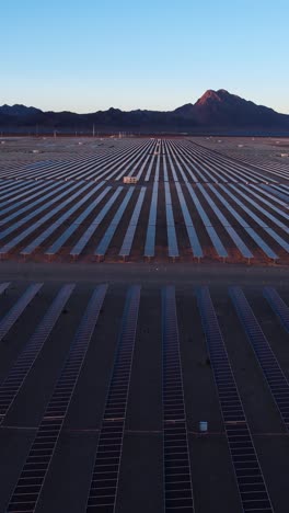 Vertical-Aerial-View,-Massive-Solar-Plant,-Arrays-of-Solar-Panels-in-Desert-Landscape