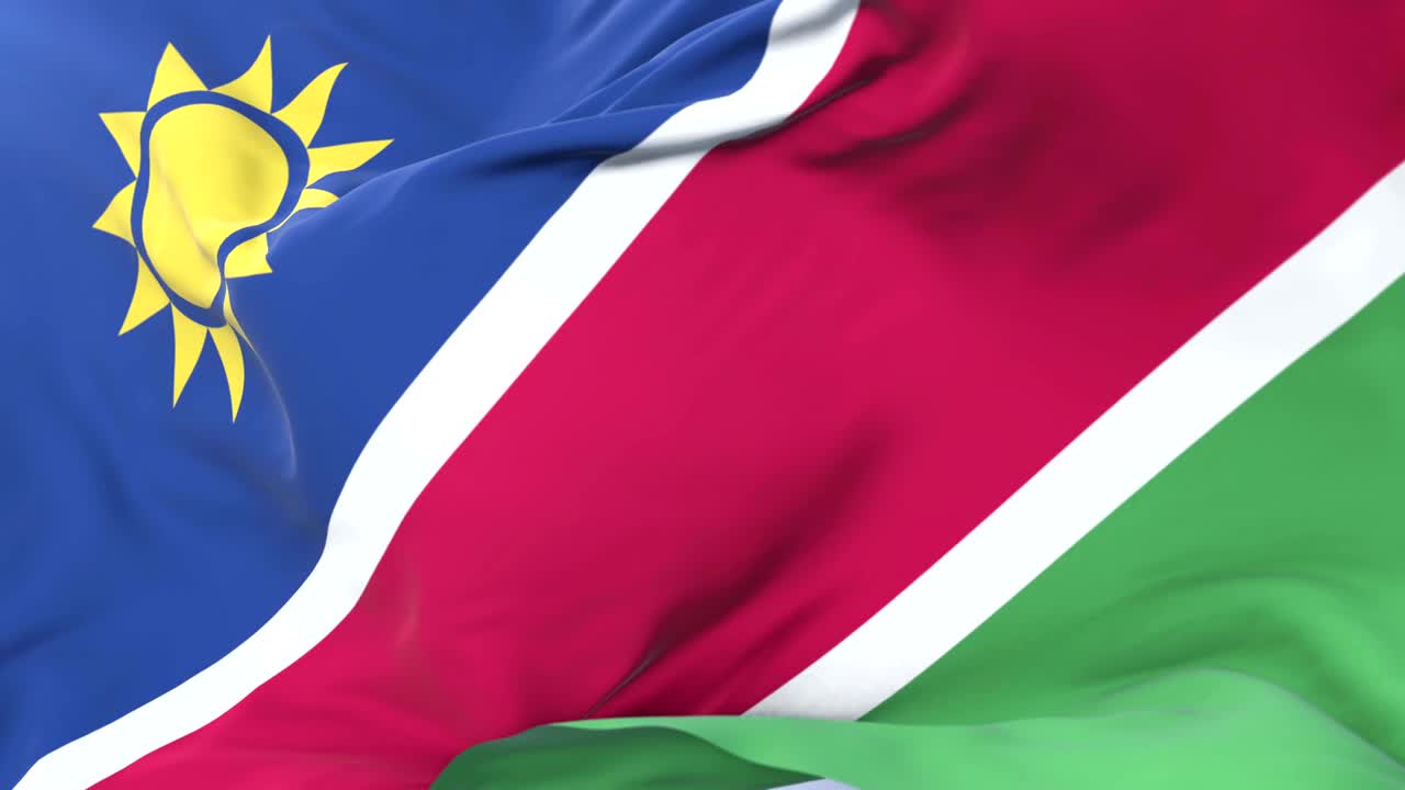 bandera de namibia agitando el viento en lento en el cielo azul, bucle