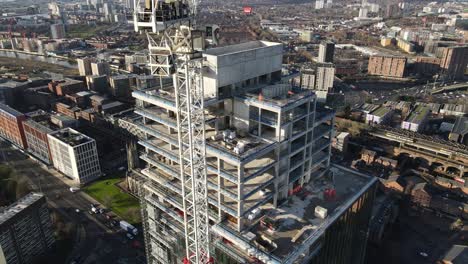 4K-60FPS-Aerial-drone-flight-overlooking-the-construction-of-a-tower-block-in-Manchester-City-Centre-showing-Castlefield-and-Deansgate-in-the-background