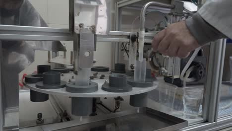 worker operating processing machine at pig insemination center