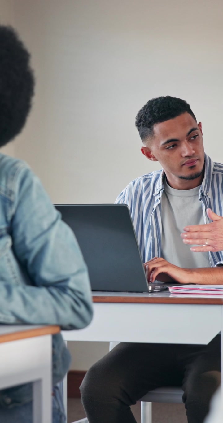 Diverse Students Collaborating on a Laptop in a Classroom