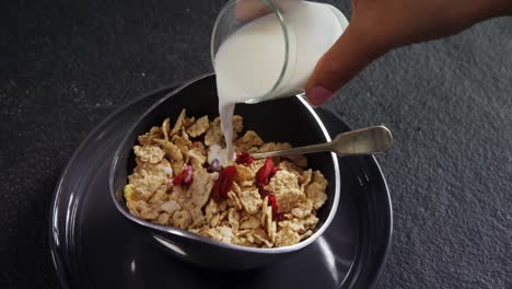 Milk-being-poured-into-wheat-flakes-bowl-4k