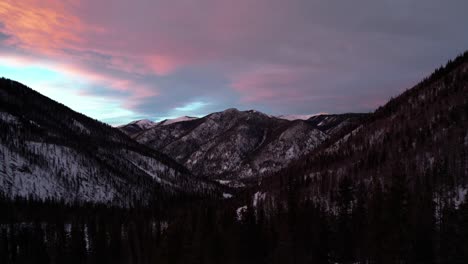 Sunset-drone-aerial-view-of-mountains-and-forest-during-dusk