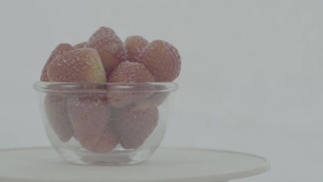 fresh, ripe, red strawberries in rotating bowl, ungraded