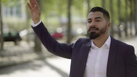 businessman catching taxi on city street