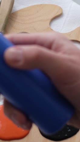 the artist prepares the paints for writing the nartina an artist works on an abstract oil painting - the artist prepares the paints for writing the nartina. an artist works on an abstract oil painting in a workshop. the concept of painting a picture