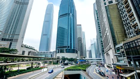 timelapse of traffic and building in hong kong. car and bus running on the road. people in the big city.