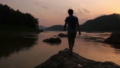 Man enjoying a sunset by the river