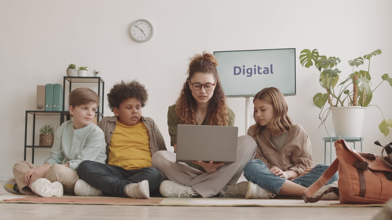 Woman and Children Using Computer on Floor