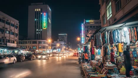 vibrant night scene of a bustling city street with a market