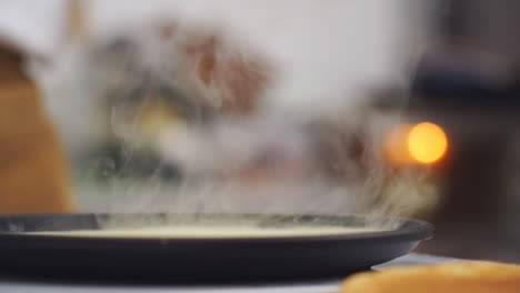 cook flipping a pancake in the frying pan