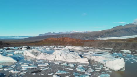 icebergs in a mud lake in skaftafell glacier mountain valley, iceland