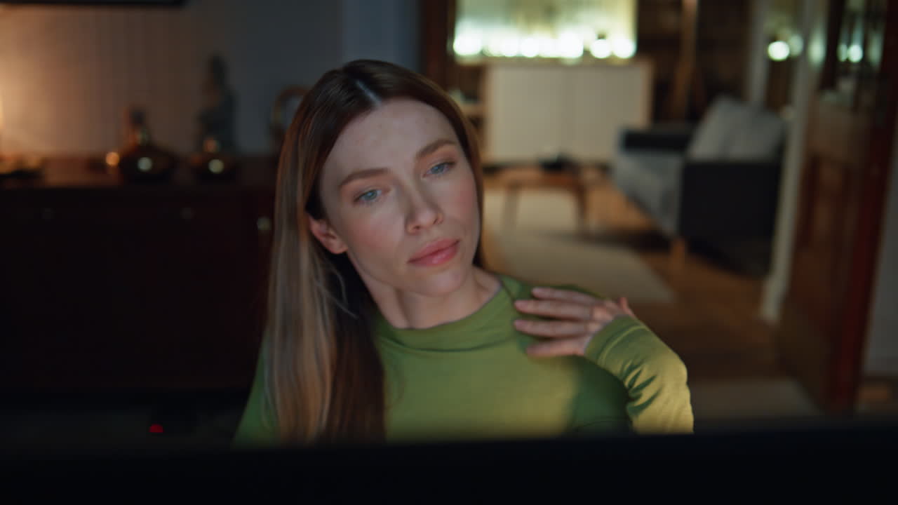 Woman watching online course in night home close up. Businesswoman working