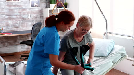 Female-doctor-helping-old-woman-with-walking-disability