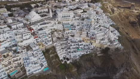 4k close aerial drone footage of santorini fira city town over caldera cliffs dramatic scenery