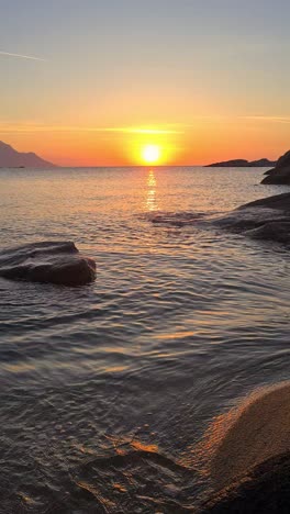 Vertical,-Sunrise-Above-Beach-and-Mediterranean-Sea,-Light-Waves-and-Sunlight