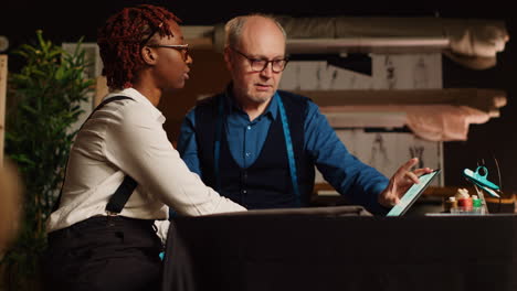 craftsman teaching trainee to sew