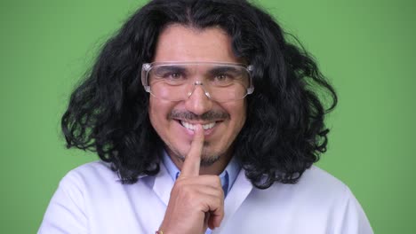 científico loco con el dedo en los labios