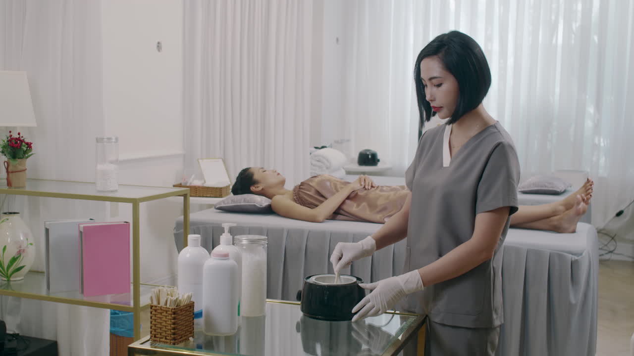 Salon Specialist Preparing Wax for Procedure of Depilation