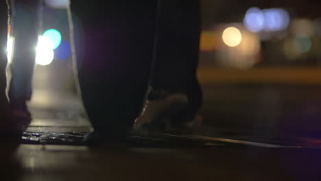 People-walking-over-steaming-manhole-at-night