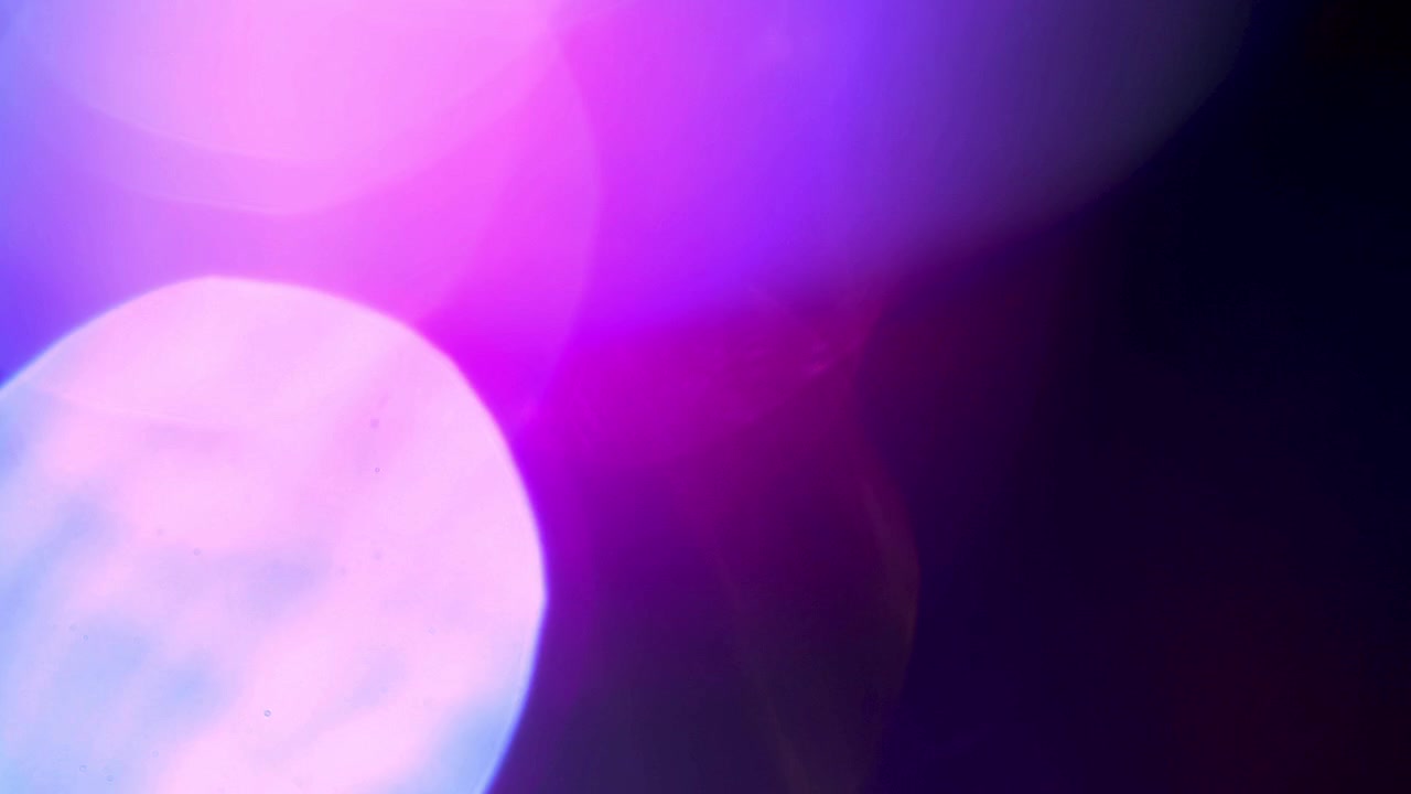 Abstract Light Leaks and Bokeh Effects on Dark Background