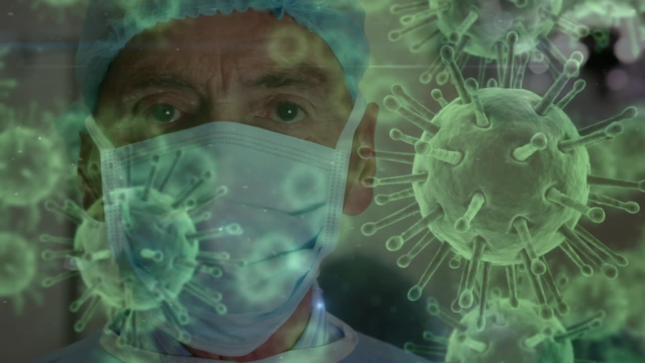 Animation of covid 19 cells over caucasian male surgeon wearing face mask in operating theatre