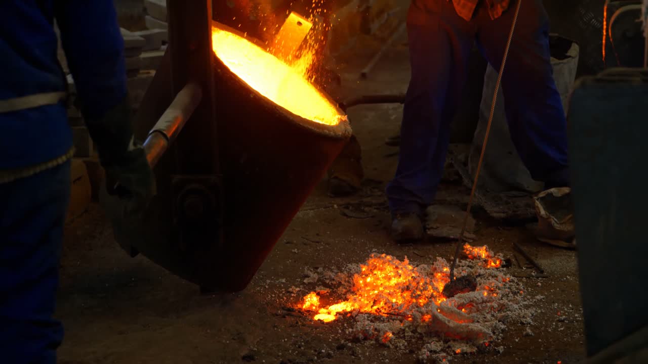 Worker mixing soil in melting molten in foundry workshop 4k