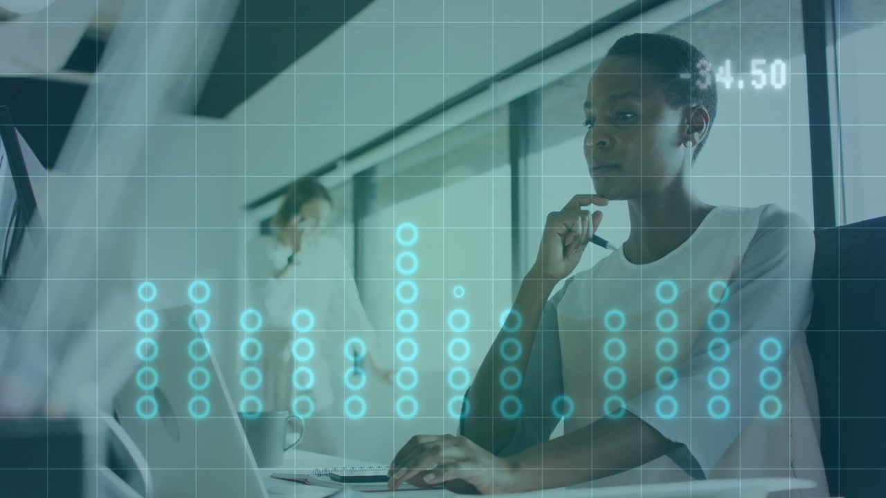 Analyzing data with digital graph overlay, businesswoman working in modern office