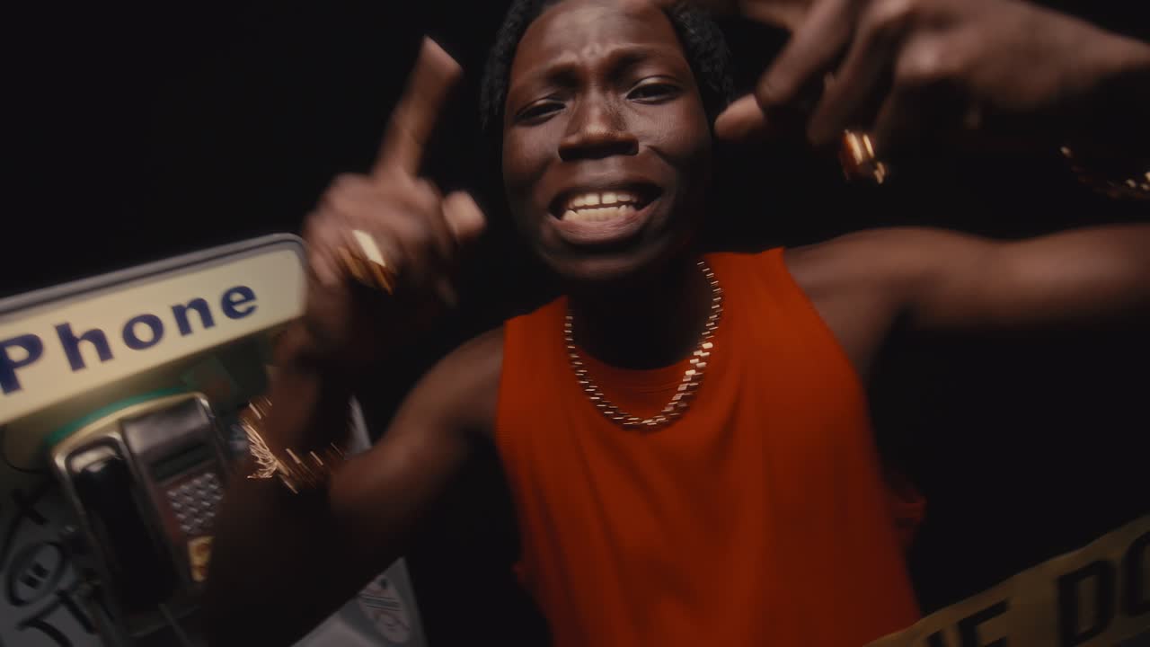 Black Rapper Performing Intensely behind Caution Tape at Gritty Crime Scene