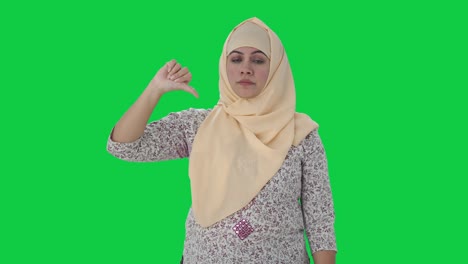 disappointed muslim teacher showing thumbs down green screen