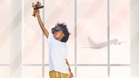 animación de un feliz niño afroamericano jugando con un juguete de avión sobre la silueta de un avión