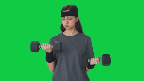 serious indian girl lifting heavy dumbbells green screen