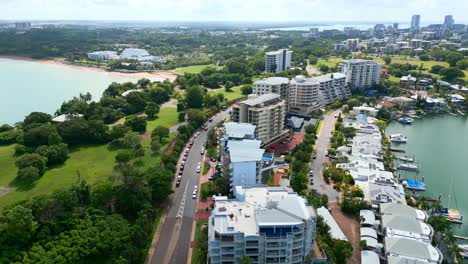 aerial drone of cullen bay and marina with cars driving along road in darwin nt australia