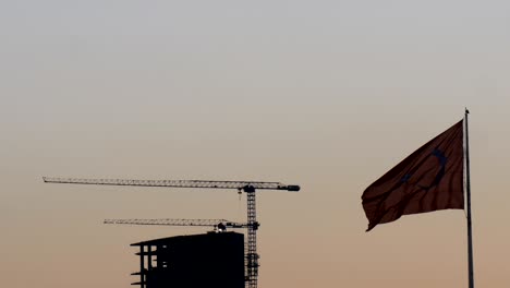 turkish flag waving front of turkish economy’s dynamo construction / building at sunset 4k dci