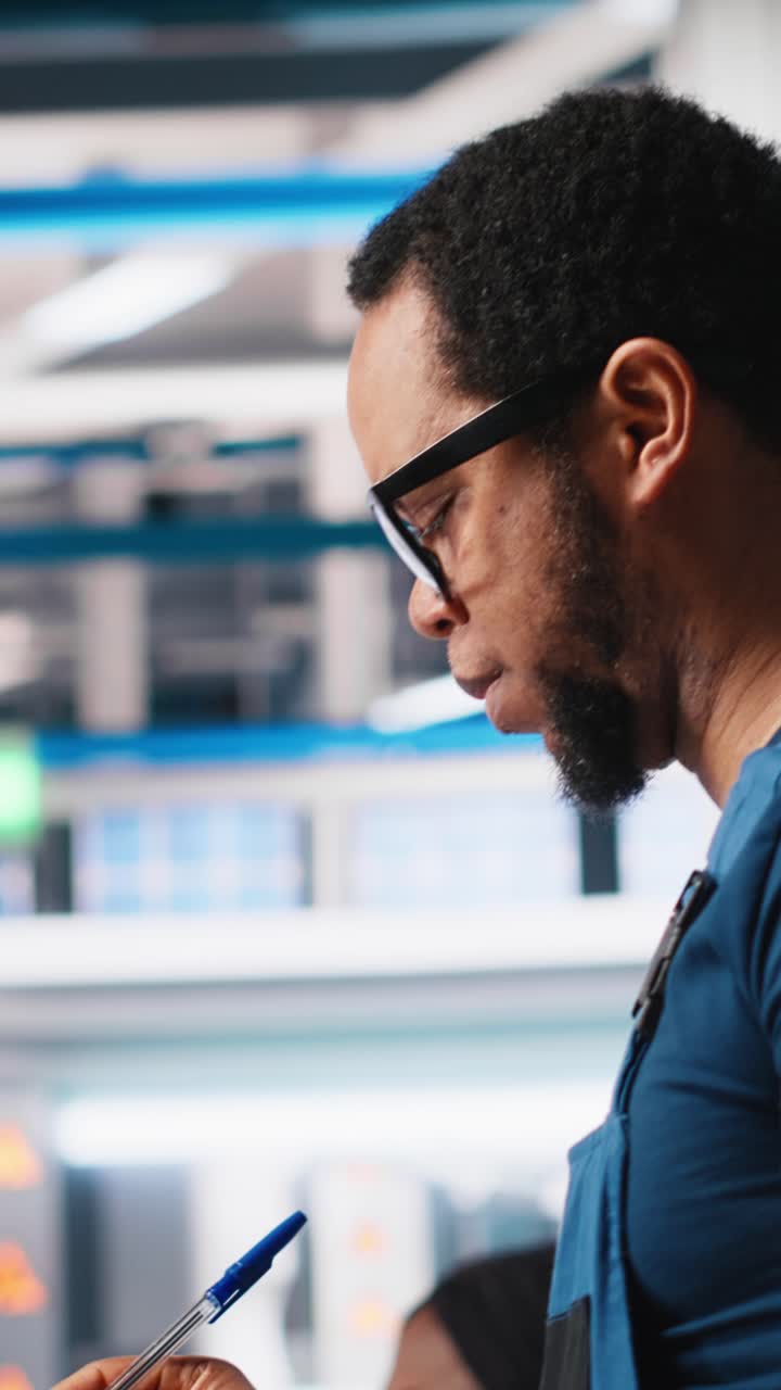 Vertical Video Portrait of engineer in photovoltaics factory reviewing paperwork