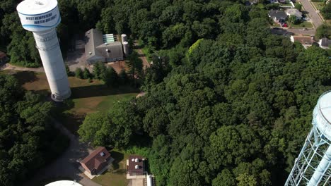 An-aerial-view-over-water-towers-in-a-suburban-neighborhood-on-Long-Island,-NY-on-a-sunny-day