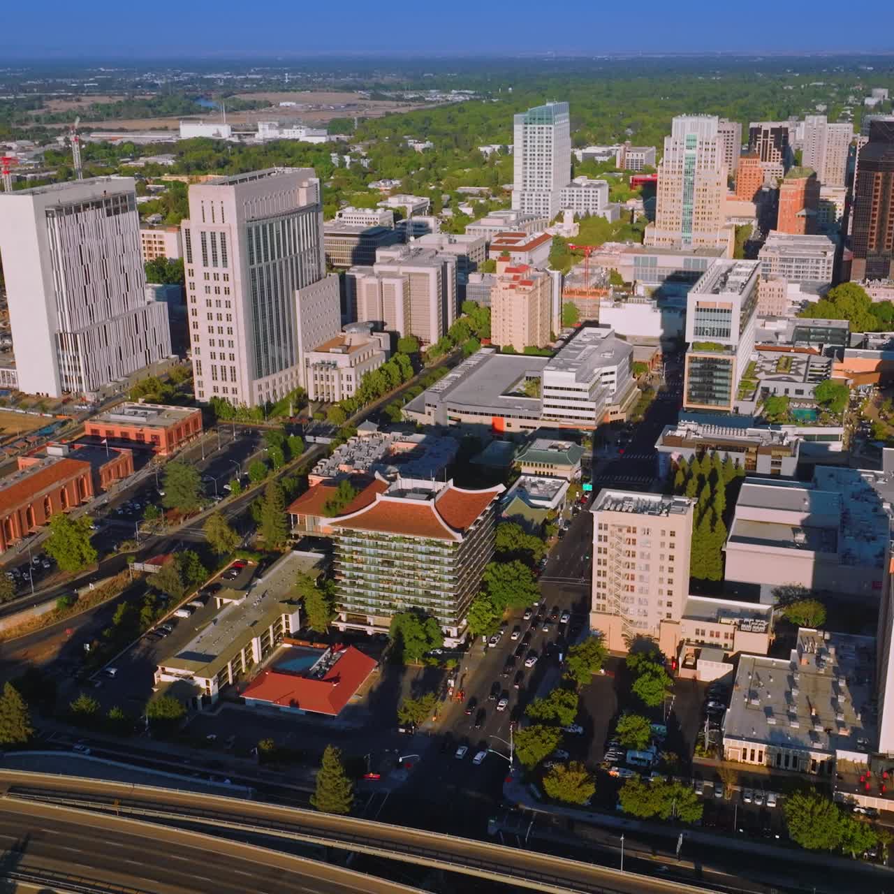 Lively traffic of Sacramento, California, USA. Drone approaching the beautiful downtown with fine architecture on sunny day