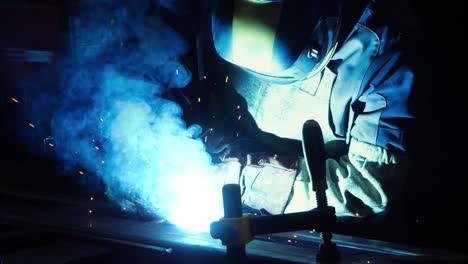 professional welder working with argon-arc welding at plant. technician welding