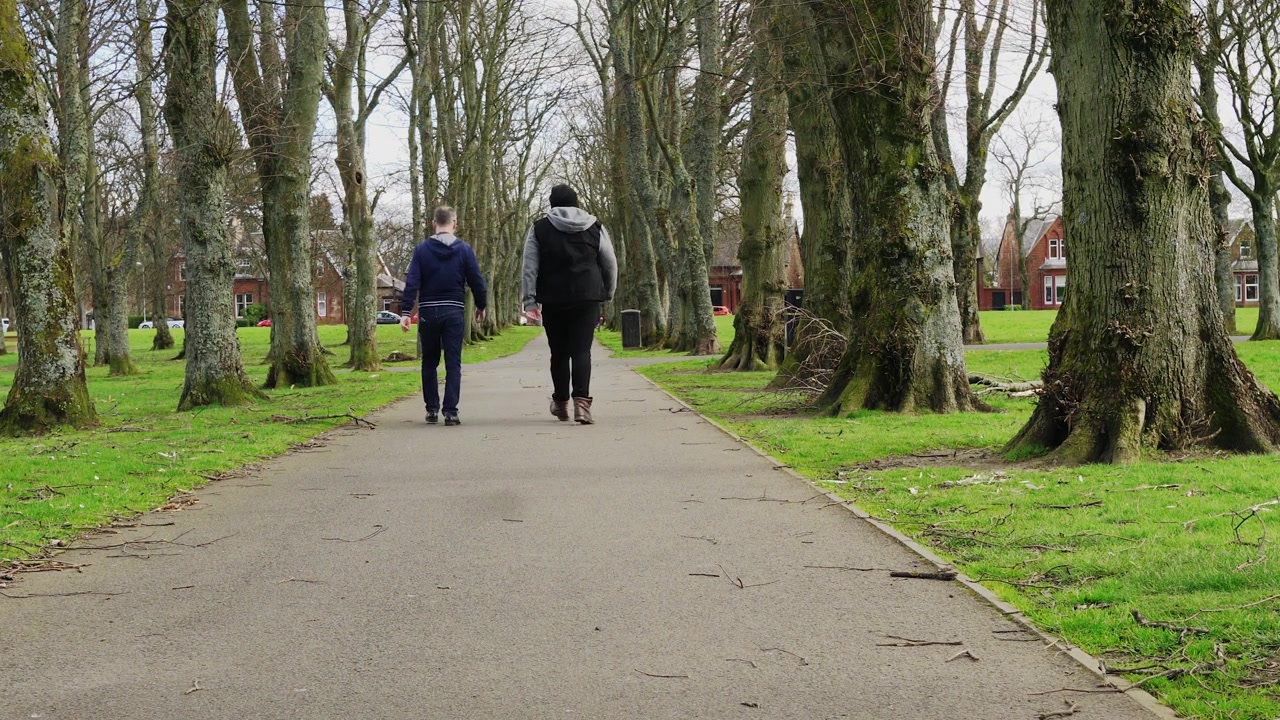 Two men walking in the local park