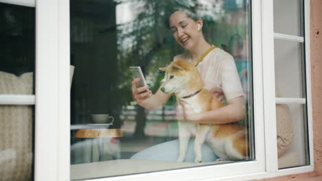 woman and dog enjoying time in a cafe