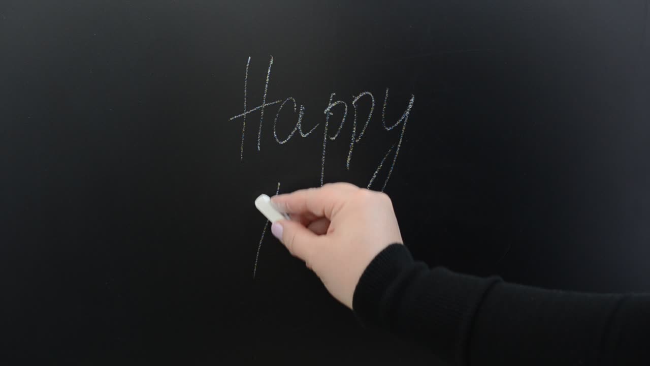 Scriviamo su una lavagna la frase "giorni felici". Scritta con il gesso su una lavagna.